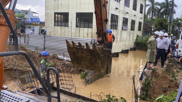 Dùng bao cát bịt miệng cống, ngăn nước lũ tràn vào trung tâm TP.Quảng Ngãi cũ